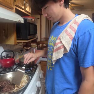 Ricky frying venison burgers
